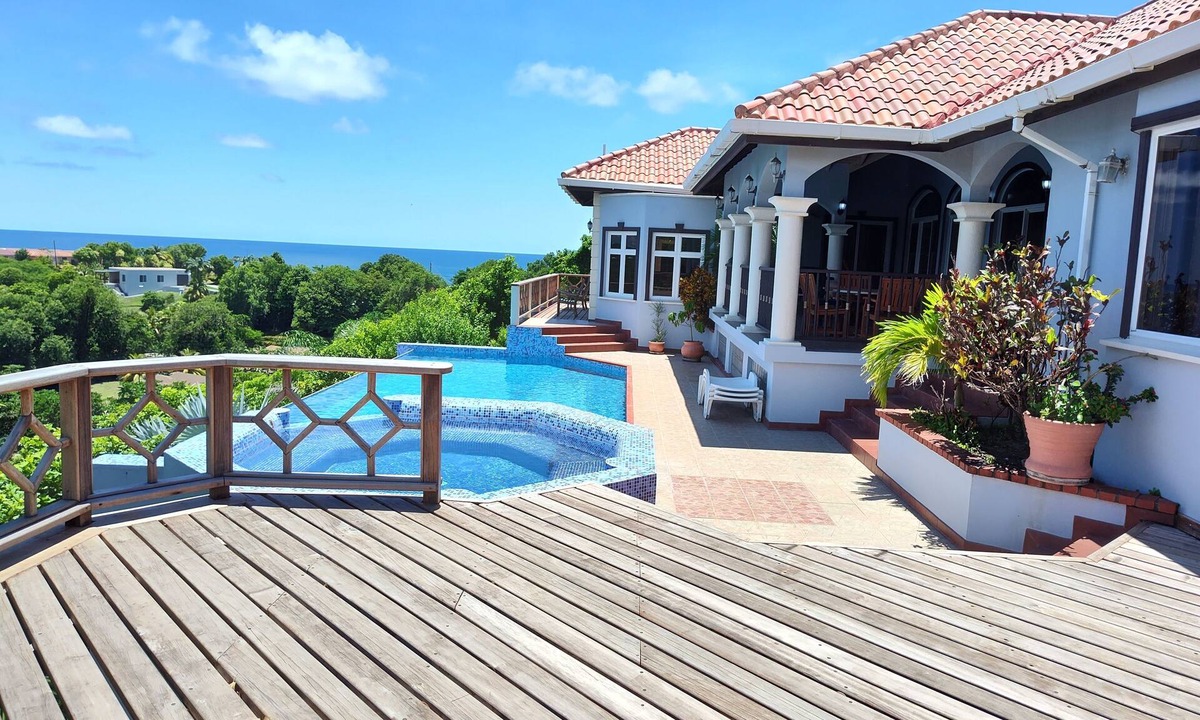 Arawak Hill Villa | Enjoy the tropical breezes & coral reef views while sitting by the pool!