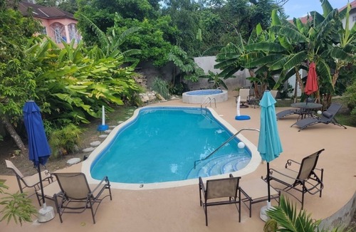 Tower Isle House | Elegant Estate Home Ocean/view . balconies Garden/pool view lush greenery