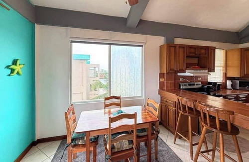 San Pedro Condo | Ocean-view home with balcony, swimming pool & central AC