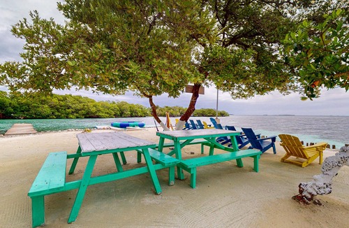 Sittee Point Apartment | Rustic overwater cabin with oceanfront deck, island kitchen & sea breeze views