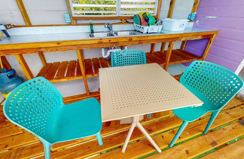 Sittee Point Apartment | Rustic overwater cabin with oceanfront deck, island kitchen & sea breeze views