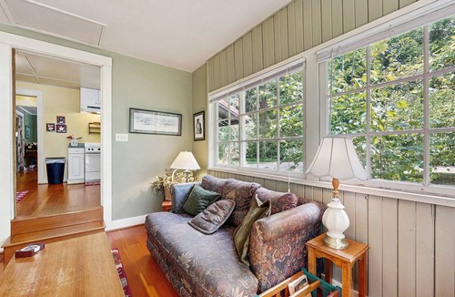 Molalla House | Tranquil landscape with riverside firepit, gas grill, gas fireplace, and deck