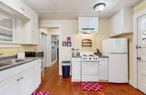 Molalla House | Tranquil landscape with riverside firepit, gas grill, gas fireplace, and deck