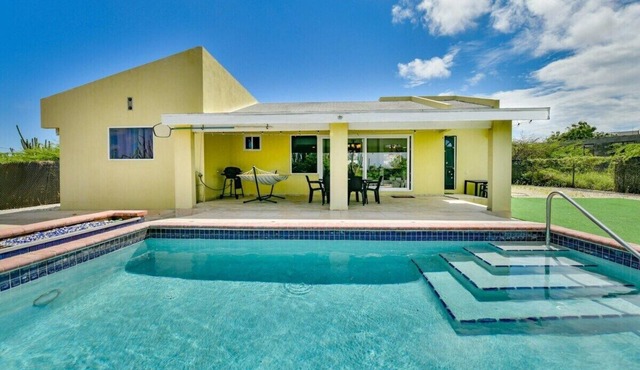 Escape to Happy Daze Villa, a sunny 3-bedroom, 2-bathroom vacation home in a charming yellow setting